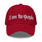 Red low-profile dad hat with embroidered I Am the People front design, front view