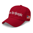 Red low-profile dad hat with embroidered I Am the People design, left front view