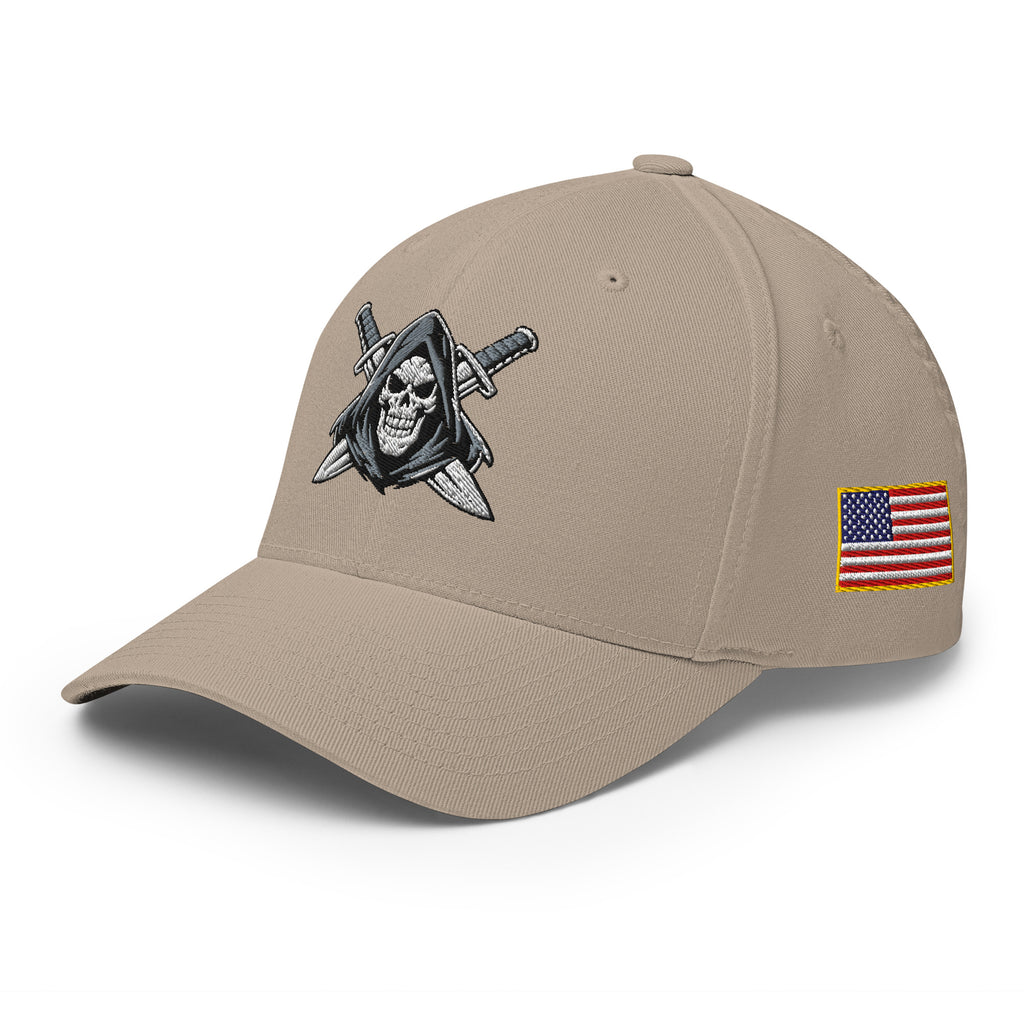Beige cap with skull and sword emblem and American flag patch on a white background