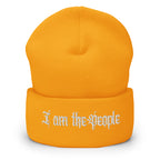 Gold cuffed knit beanie with embroidered I Am the People front design, front view