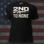 Black t-shirt with '2nd to None' text and rifle graphic on an American flag background