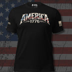 Infidel Collective black tee with American flag-filled “AMERICA 1776” front lettering