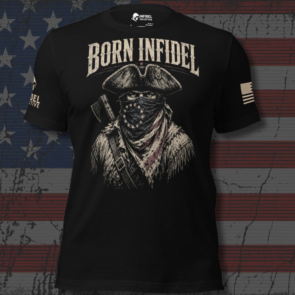 A black short-sleeve graphic t-shirt featuring a distressed print of a bandit wearing a tricorn hat and bandana with the text 'BORN INFIDEL' across the chest. The shirt is displayed against a distressed American flag background.