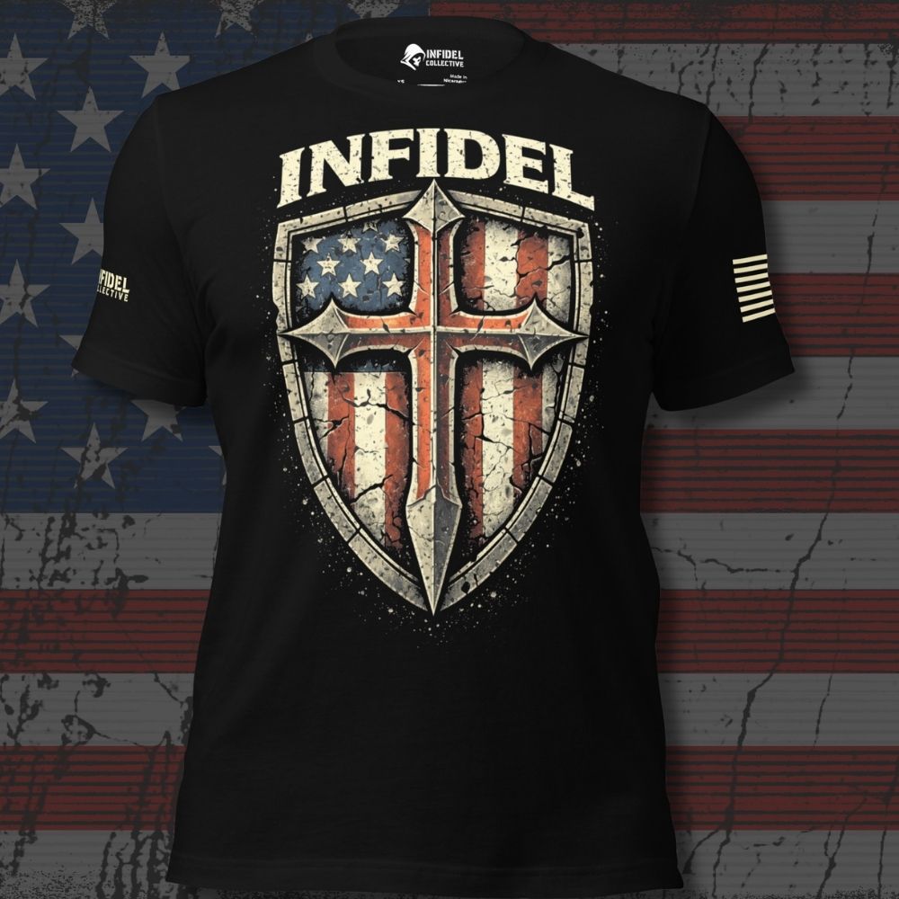 A black short-sleeve graphic T-shirt with a large distressed shield design on the front. The shield contains an American flag motif with a central cross, and the word "INFIDEL" appears above it in large cream letters.