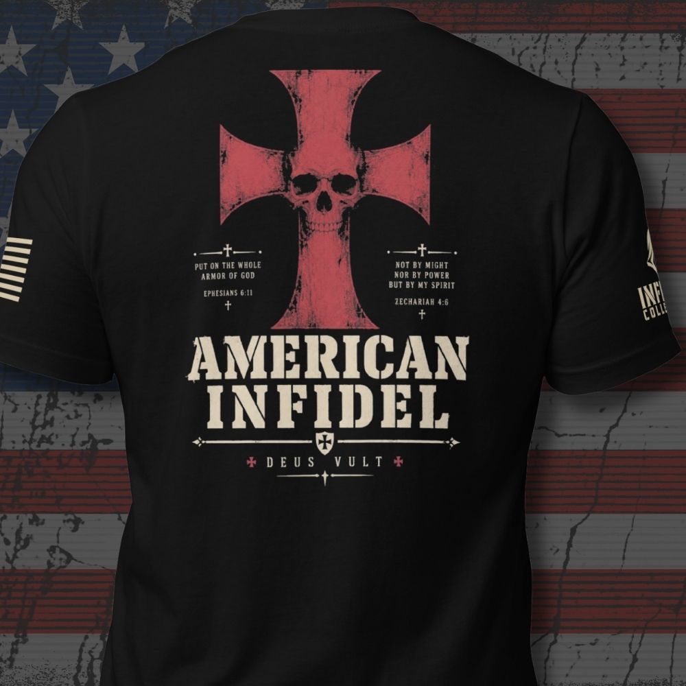 Infidel Collective black back-print tee with red cross, skull, “AMERICAN INFIDEL,” and “DEUS VULT” graphic - includes an American USA flag on left sleeve and brand logo on the right sleeve.