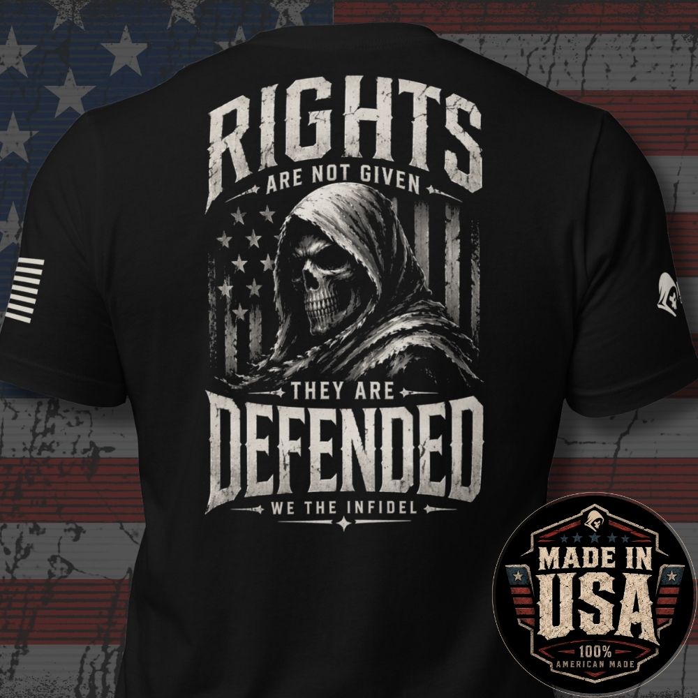 Black short-sleeve graphic T-shirt shown from the back, featuring a large distressed white print of a hooded skull over an American flag with the text 'RIGHTS ARE NOT GIVEN THEY ARE DEFENDED WE THE INFIDEL'. A circular 'Made in USA 100% American Made' badge appears in the lower right corner, and a distressed American flag background is visible behind the shirt.