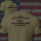 Heather military green t-shirt shown from both front and back against a distressed American flag background. The front features black text reading 'FRONT TOWARD ENEMY' and a small black flag graphic on the sleeve.