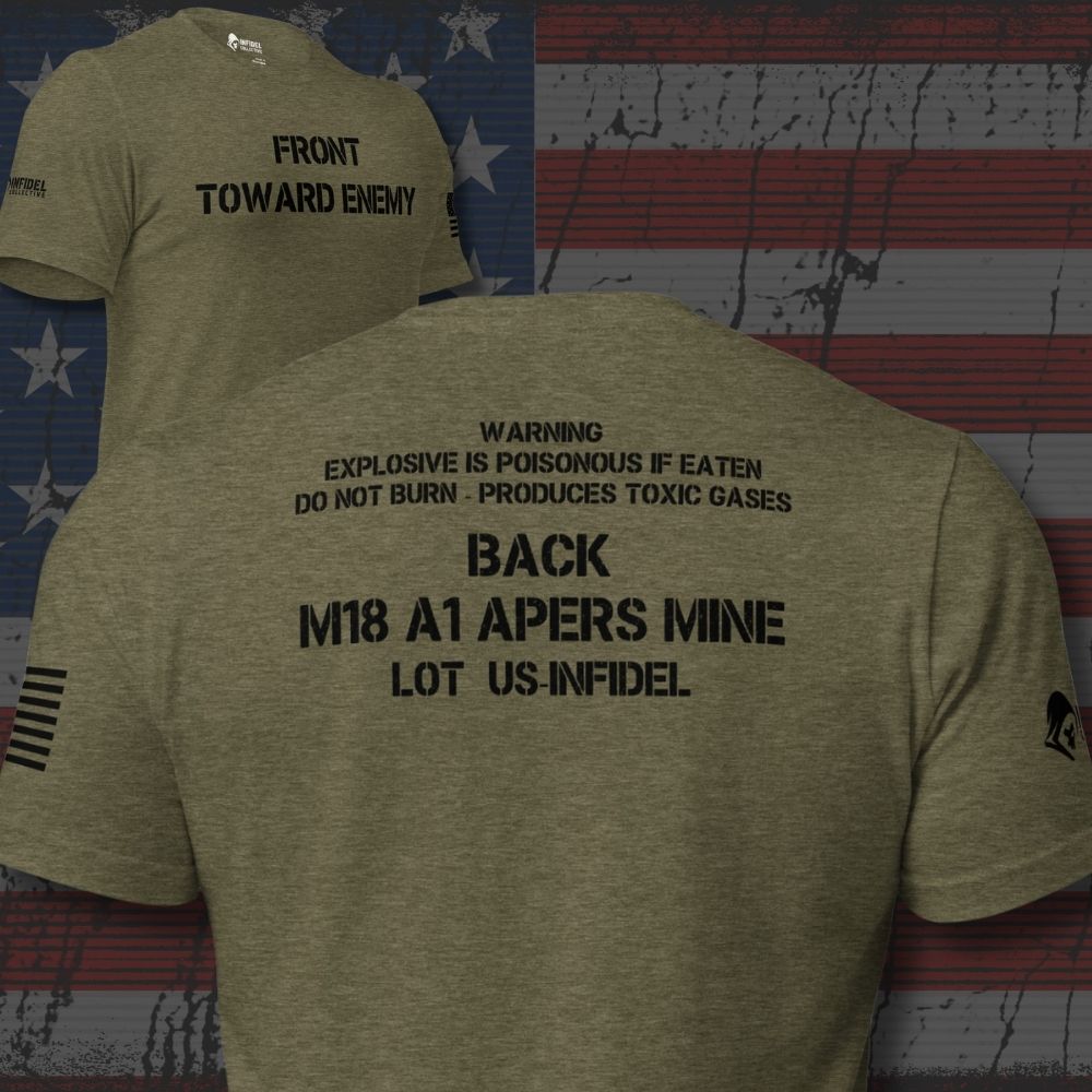 Heather military green t-shirt shown from both front and back against a distressed American flag background. The front features black text reading 'FRONT TOWARD ENEMY' and a small black flag graphic on the sleeve.