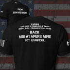 Infidel Collective black double-sided tee with “FRONT TOWARD ENEMY” front print and Claymore mine warning text on the back