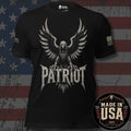 A black short-sleeve graphic T-shirt featuring a large distressed eagle with spread wings and the word "PATRIOT" in bold lettering below. USA American flag on the left sleeve and brand logo 'INFIDEL COLLECTIVE' on the right sleeve. The shirt is shown against a rustic American flag background. 100% Made in the USA.