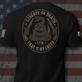 Infidel Collective black tee with coiled rattlesnake, flintlock pistols, “LIBERTY OR DEATH,” “1776,” and “THAT IS MY CREED” back print