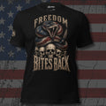 American flag rattlesnake coiled over skulls with Freedom Bites Back text front print black tee from Infidel Collective