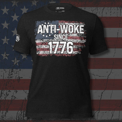 Black t-shirt with 'ANTI-WOKE SINCE 1776' text and American flag design on a distressed American flag background.