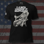 E-4 Mafia Leadership By Disappearance front print tee with skeleton in military uniform sitting in a chair holding a coffee mug on black shirt