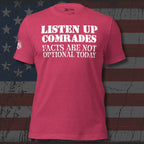 Red t-shirt with white text 'Listen Up Comrades Facts Are Not Optional Today' on a distressed American flag background