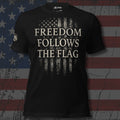 stacked Freedom Follows the Flag text over distressed flag bars front print black tee from Infidel Collective