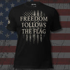 Black t-shirt with 'Freedom Follows the Flag' text on an American flag background