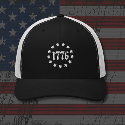 Black and white cap with '1776' design on a distressed American flag background
