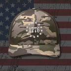 Camouflage cap with '1776' design on an American flag background