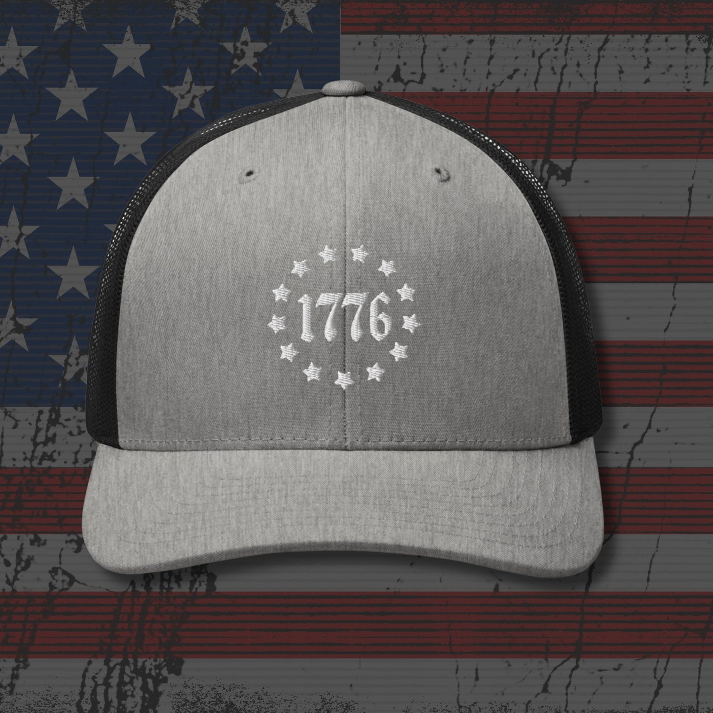 Gray and black cap with '1776' design on an American flag background