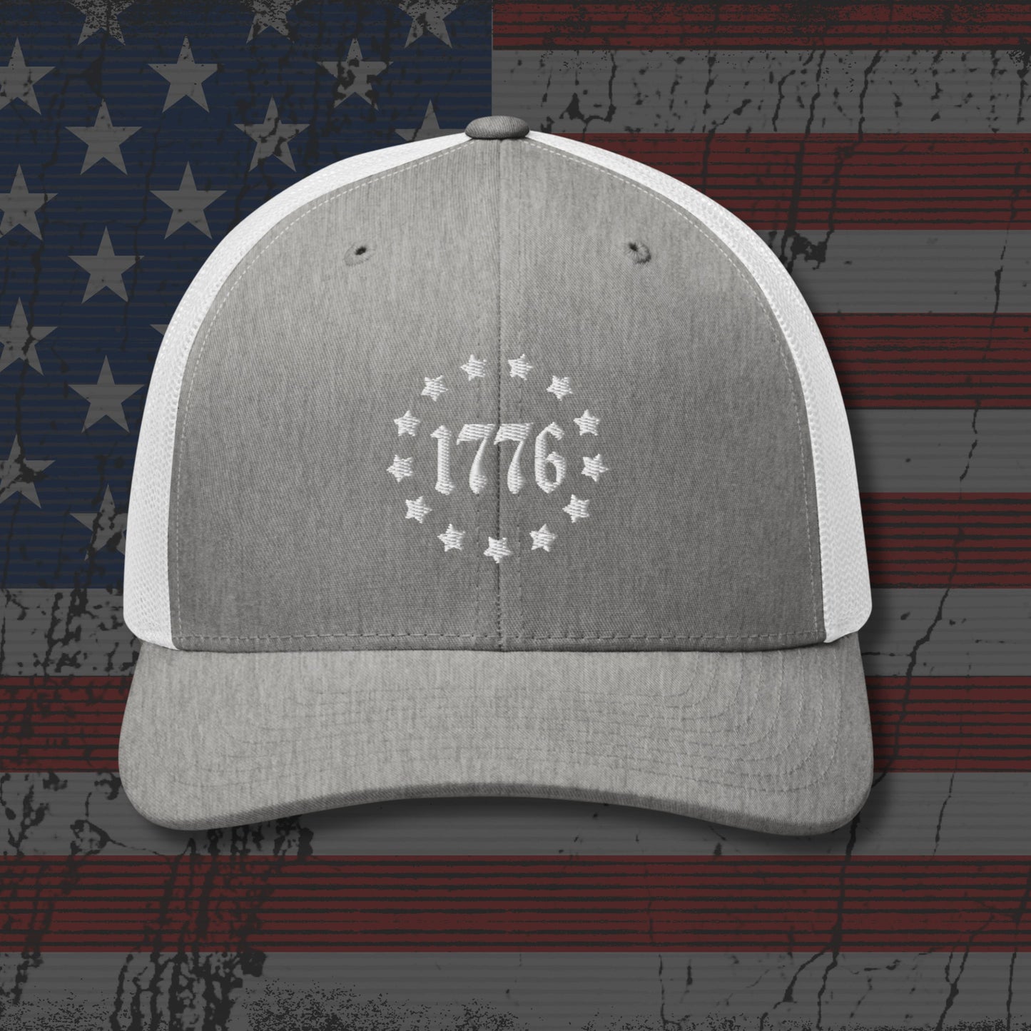 Gray and white cap with '1776' design on an American flag background