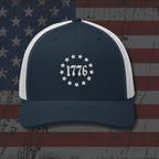 Navy and white cap with '1776' design on an American flag background