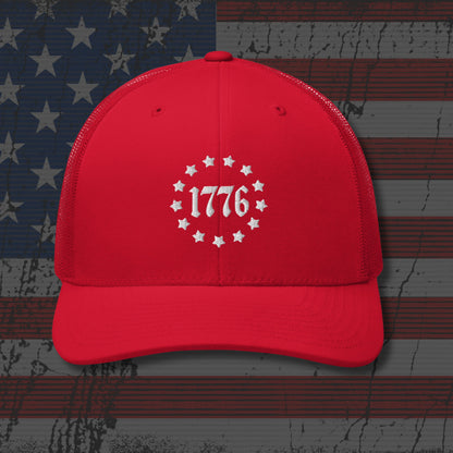 Red cap with '1776' design on a distressed American flag background