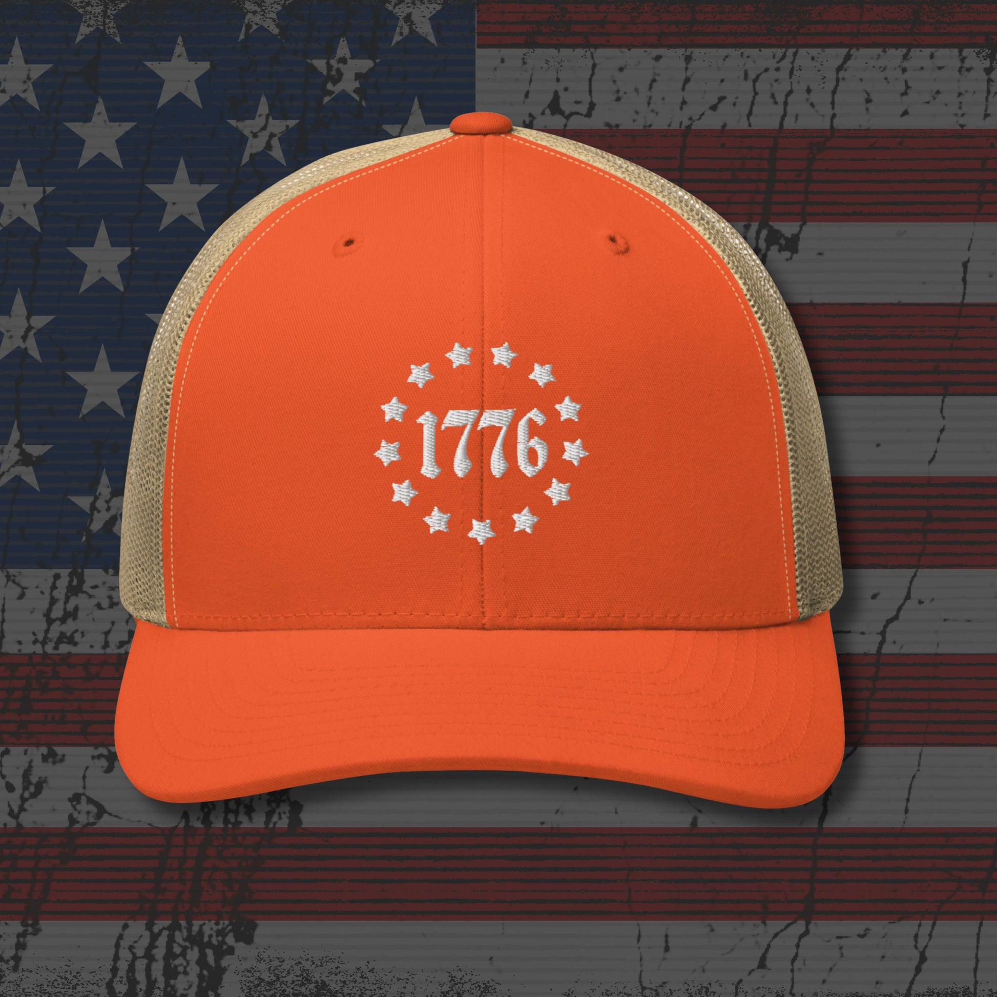 Orange cap with '1776' design on an American flag background