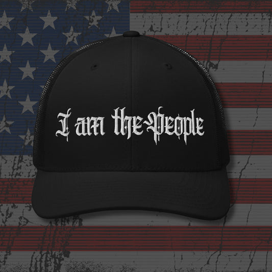 Black cap with 'I am the People' text on an American flag background