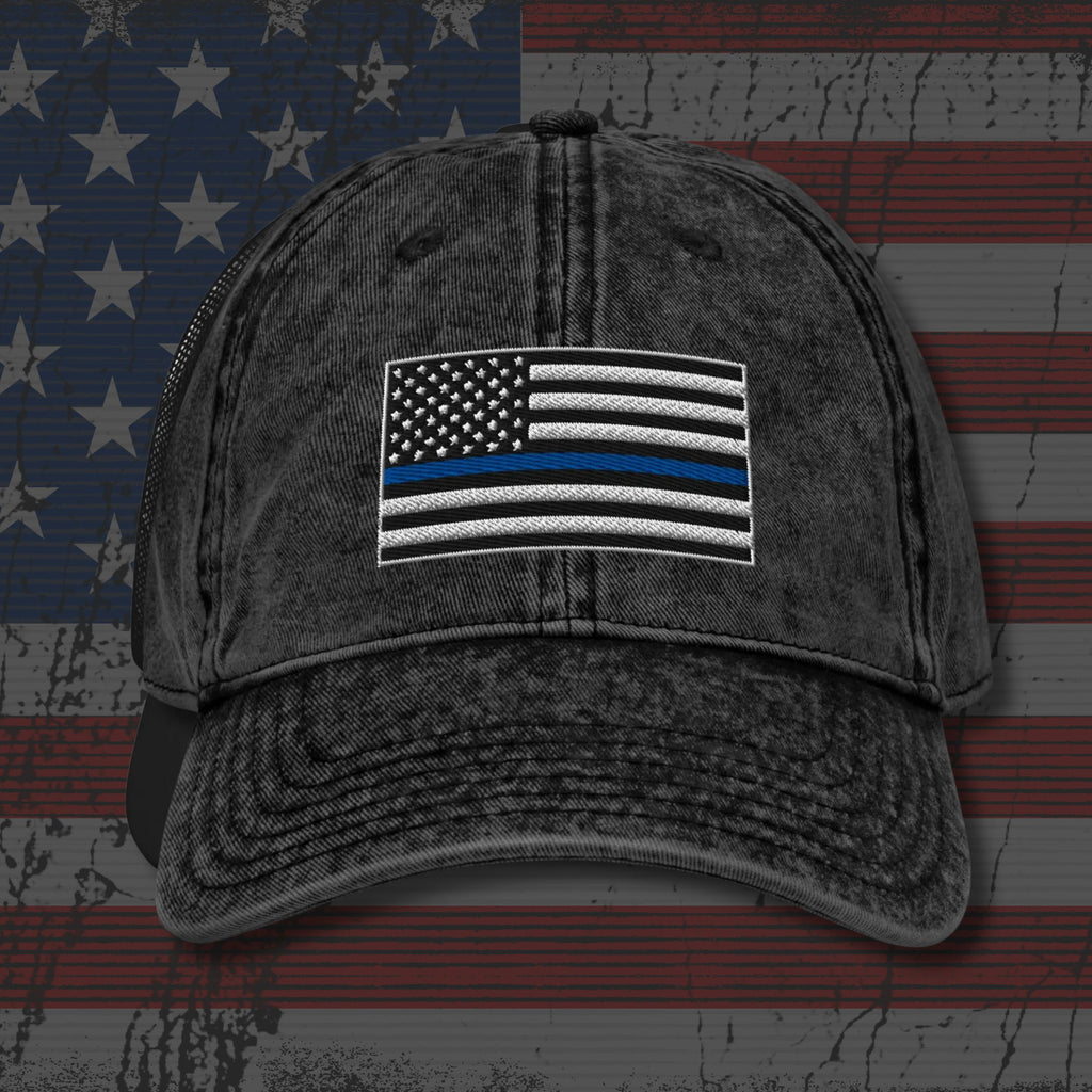 Black distressed cap with American flag patch on an American flag background
