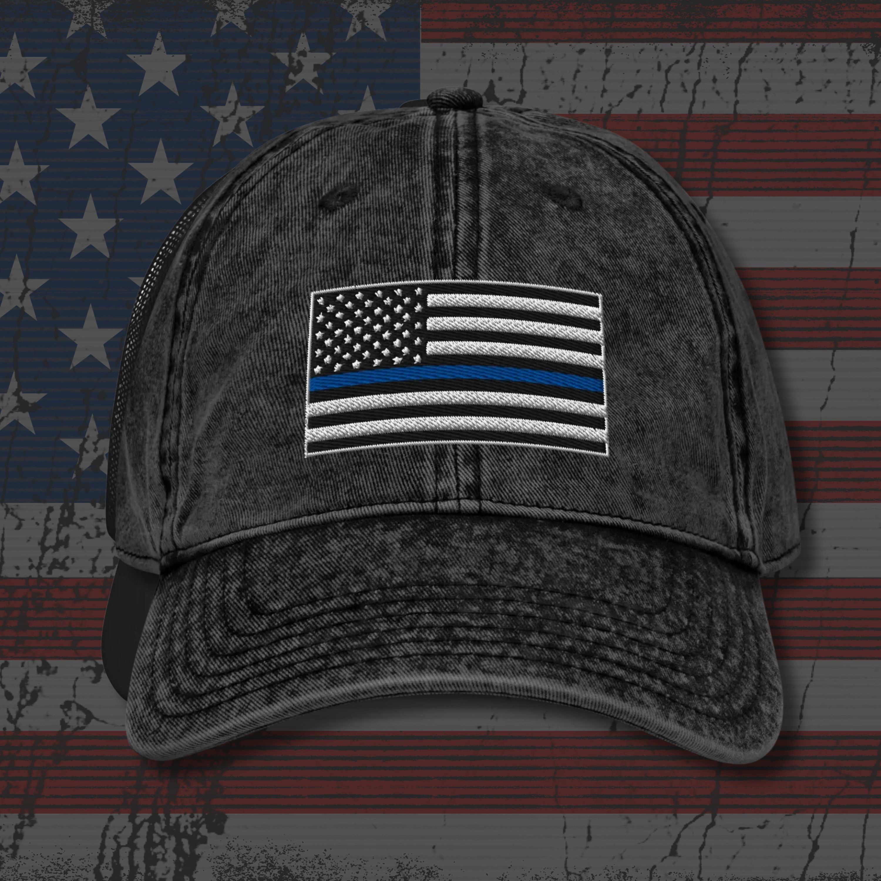 Black distressed cap with American flag patch on an American flag background
