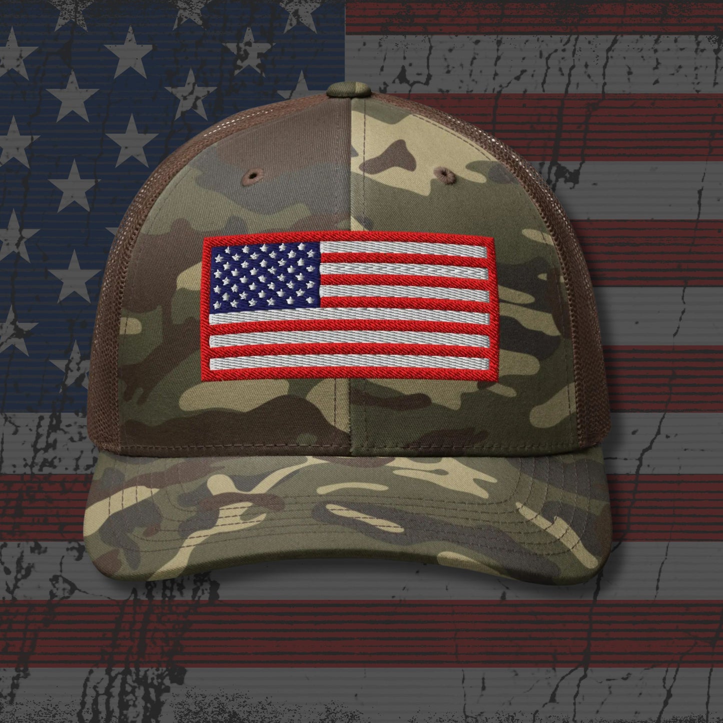Camouflage cap with American flag patch on a background resembling the American flag.