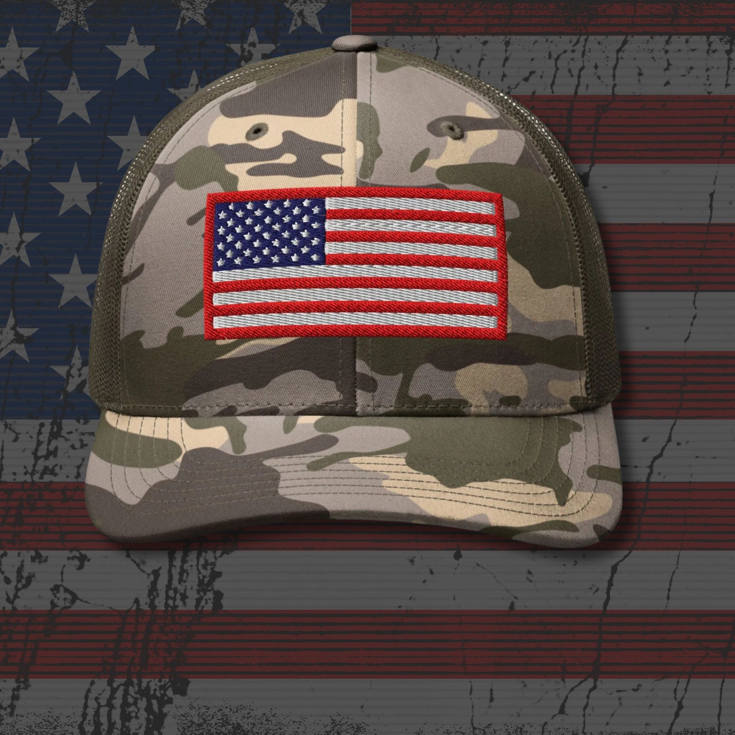 Camouflage cap with American flag patch on a background resembling the American flag.