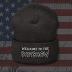 Dark gray beanie with 'Welcome to the Shitshow' text on an American flag background