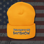 Yellow beanie with 'Welcome to the Shitshow' text on a distressed American flag background