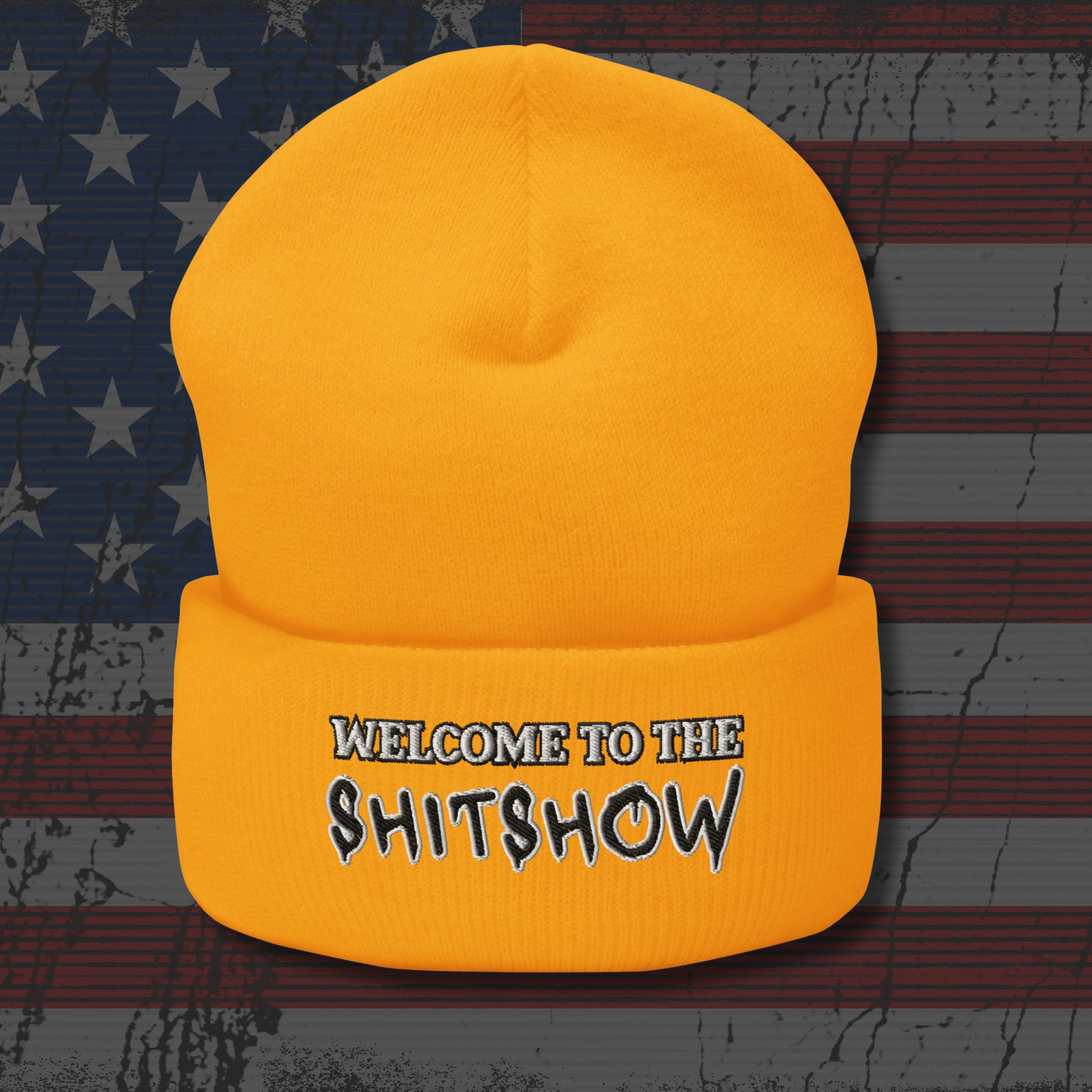 Yellow beanie with 'Welcome to the Shitshow' text on a distressed American flag background