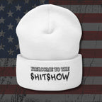 White beanie with 'WELCOME TO THE SHITSHOW' text on an American flag background