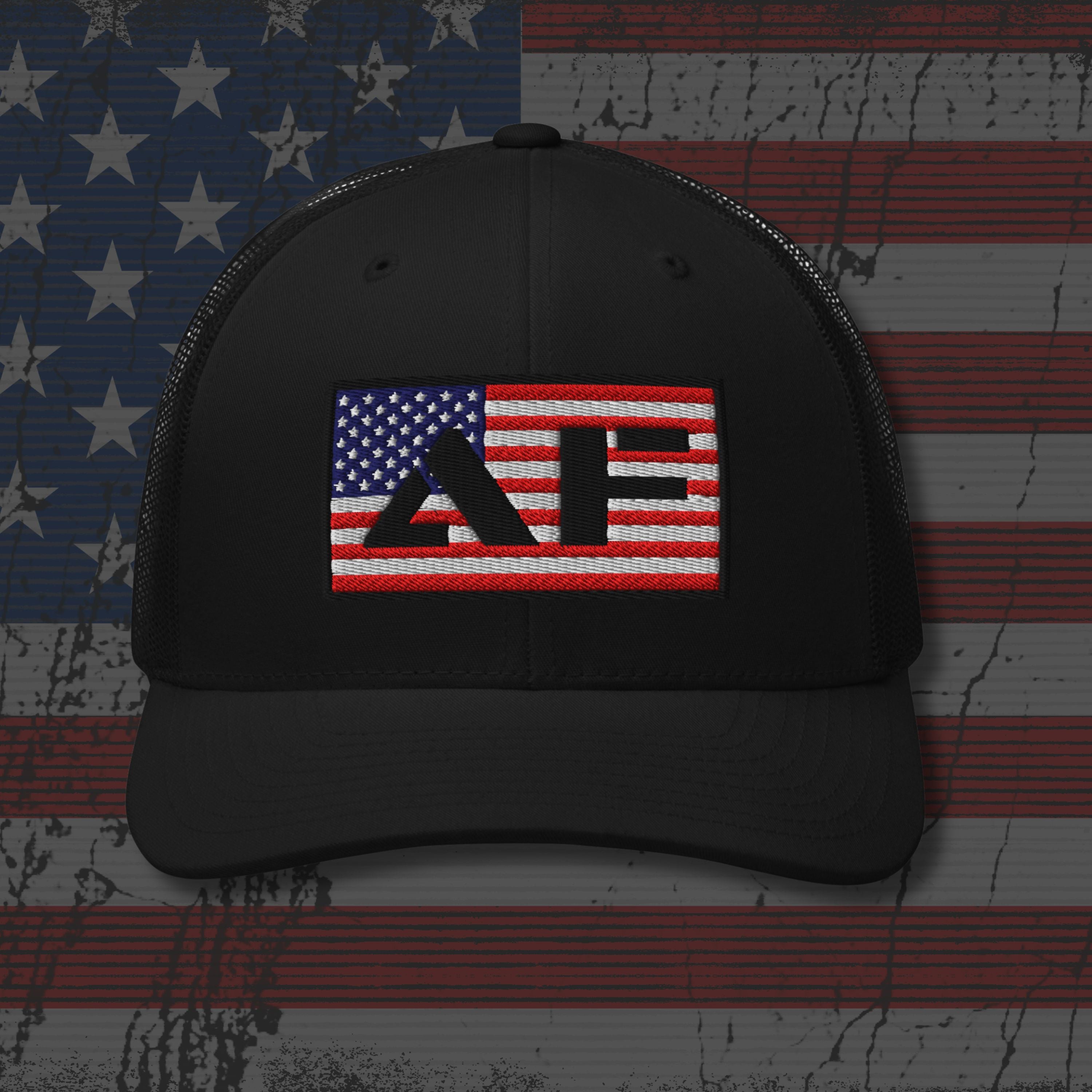 Black cap with embroidered design on an American flag background