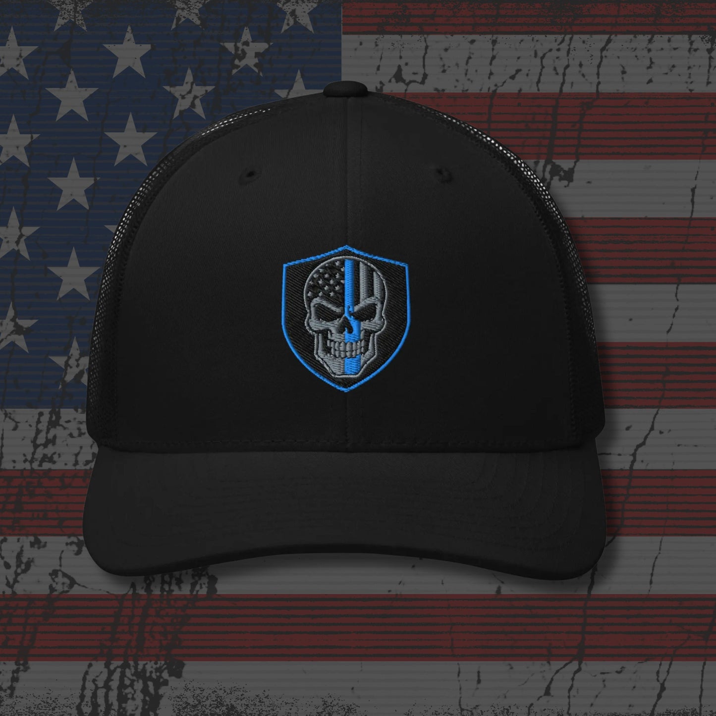 Black cap with a blue and white emblem on an American flag background