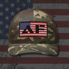 Camouflage cap with American flag and 'AF' patch on a distressed American flag background