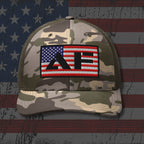 Camouflage cap with a patch featuring the American flag and text on an American flag background