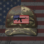 Camouflage baseball cap with American flag patch on an American flag background