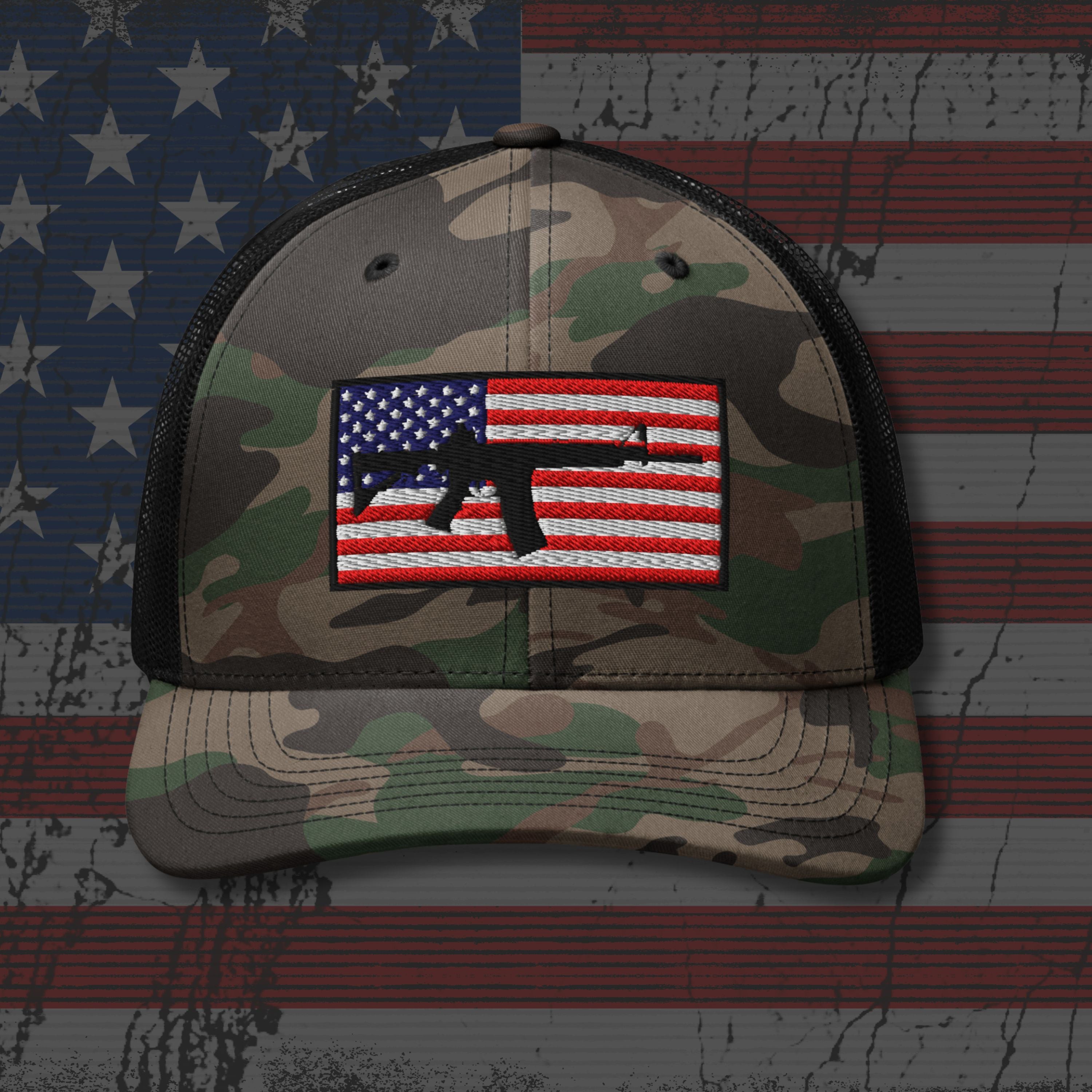 Camouflage cap with American flag patch on a background resembling an American flag.