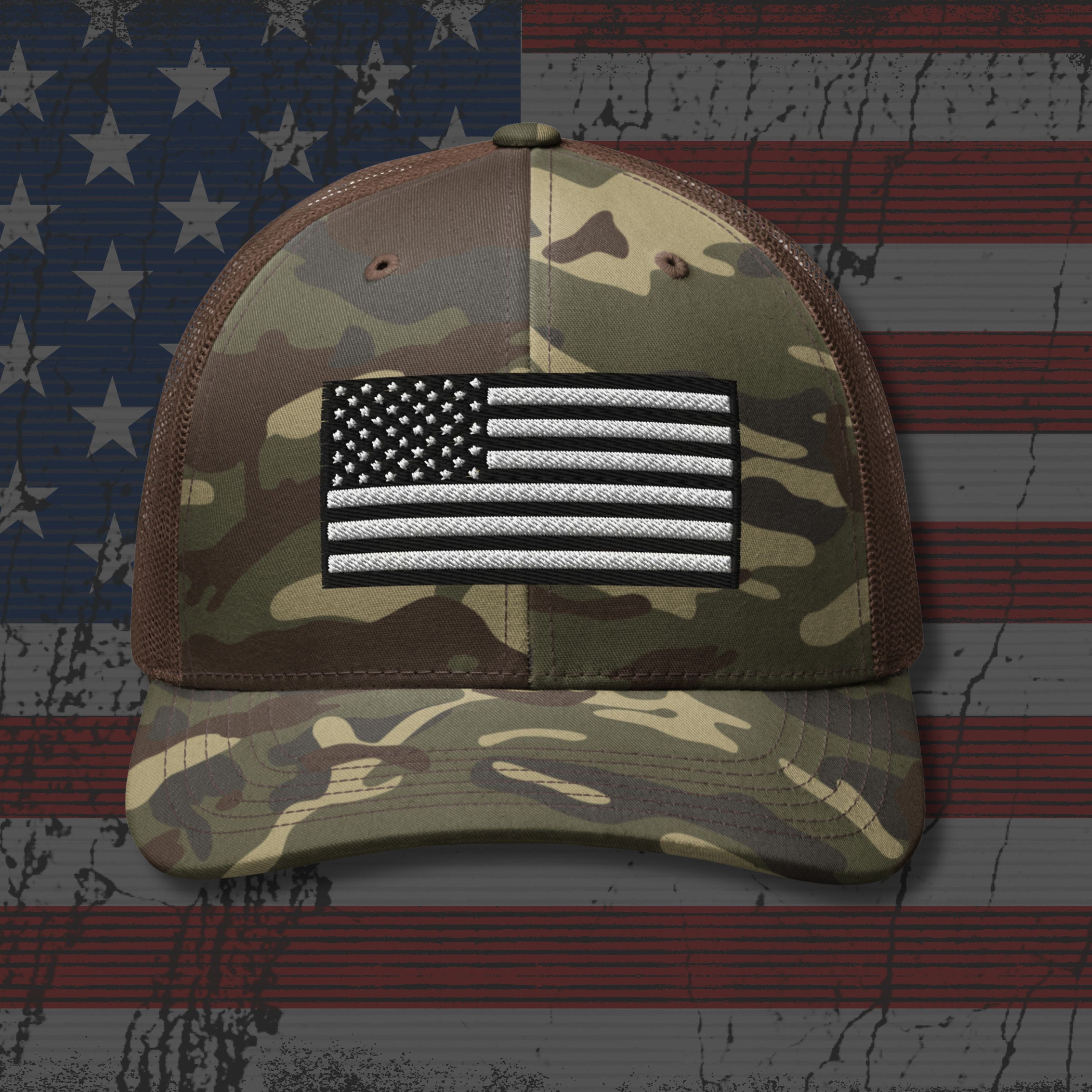 Camouflage cap with American flag patch on an American flag background