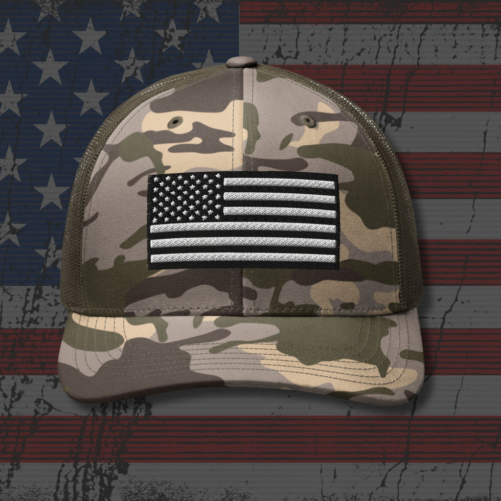 Camouflage cap with American flag patch on a distressed American flag background