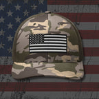 Camouflage cap with American flag patch on a distressed American flag background