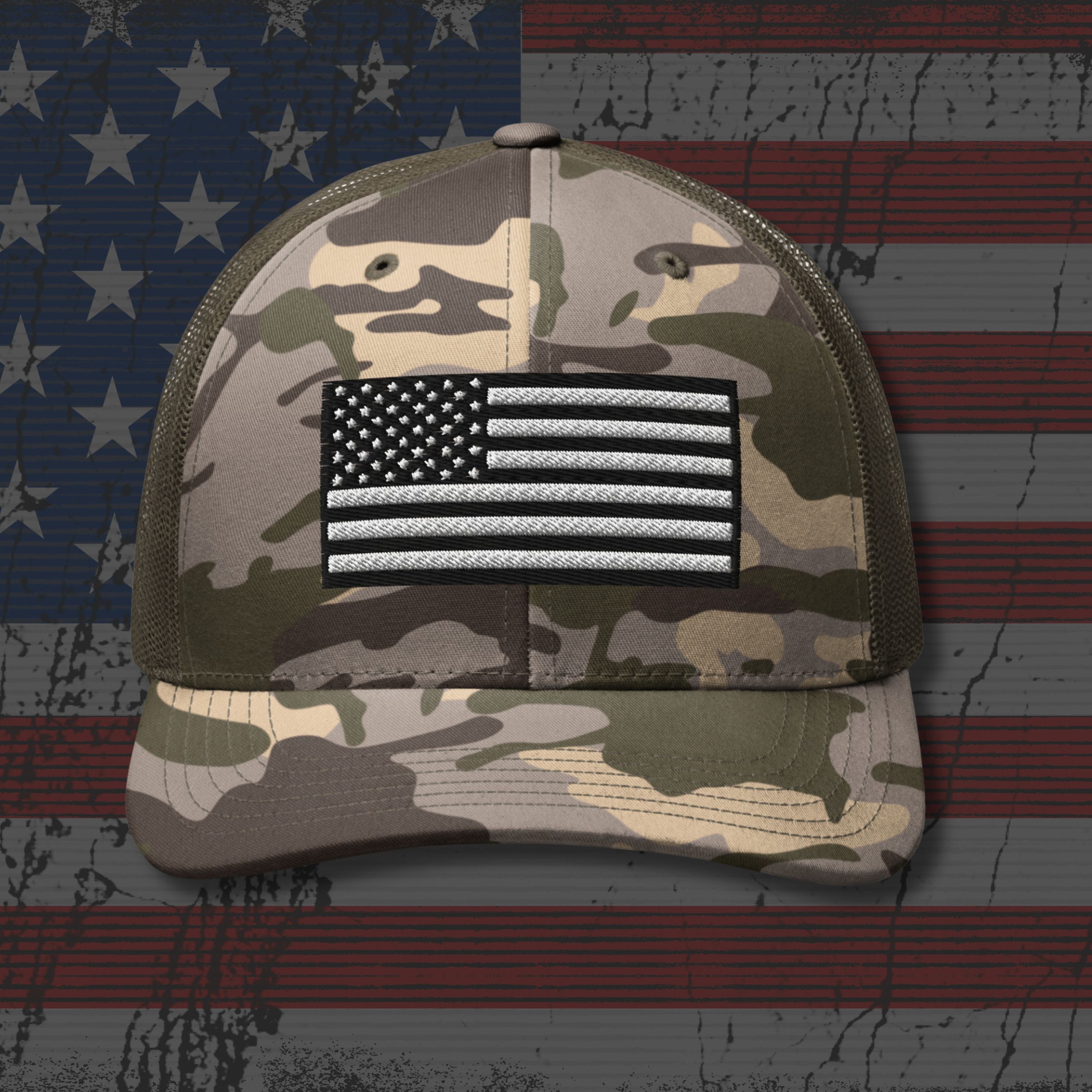 Camouflage cap with American flag patch on a distressed American flag background