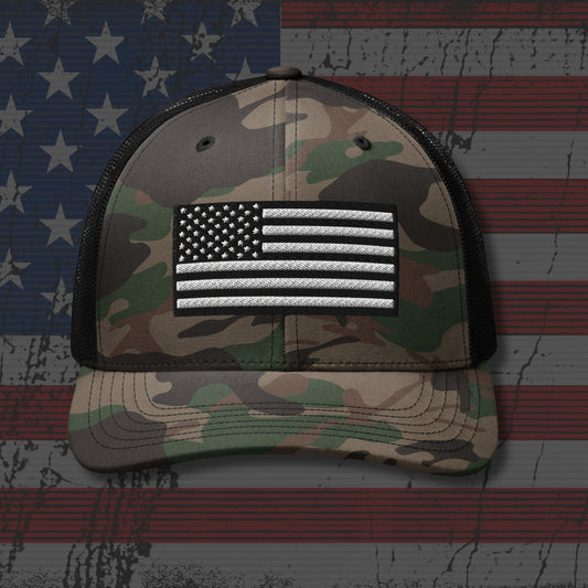 Camouflage cap with American flag patch on a distressed American flag background