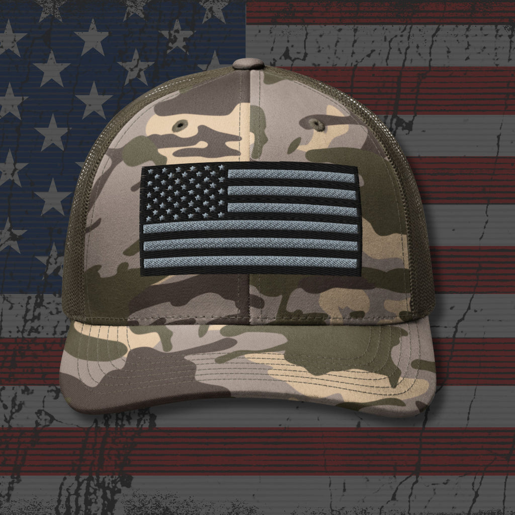 Camouflage cap with American flag patch on a distressed American flag background