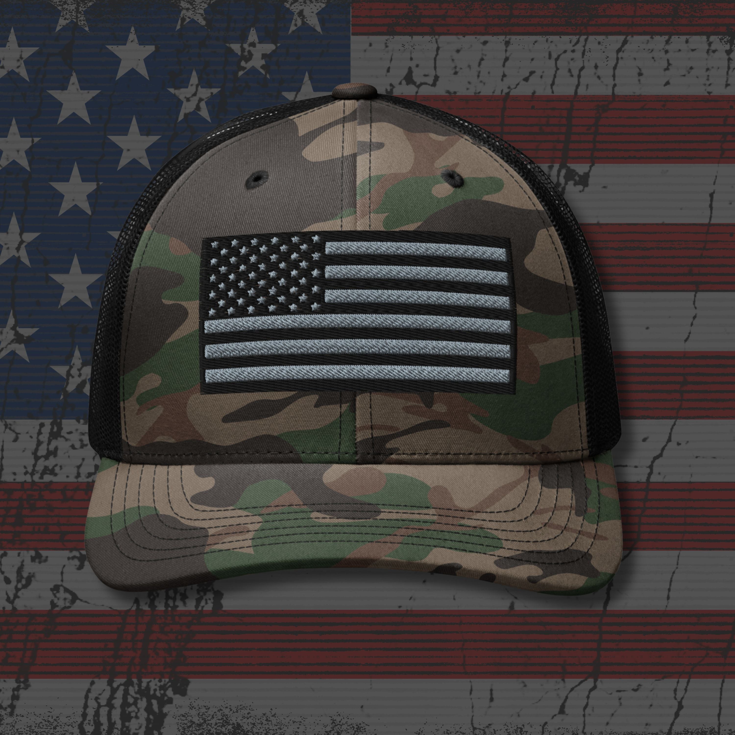 Camouflage cap with American flag patch on an American flag background